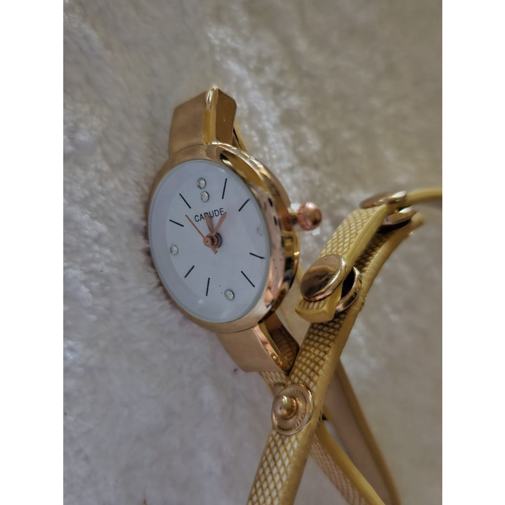 Gold toned bracelet watch.